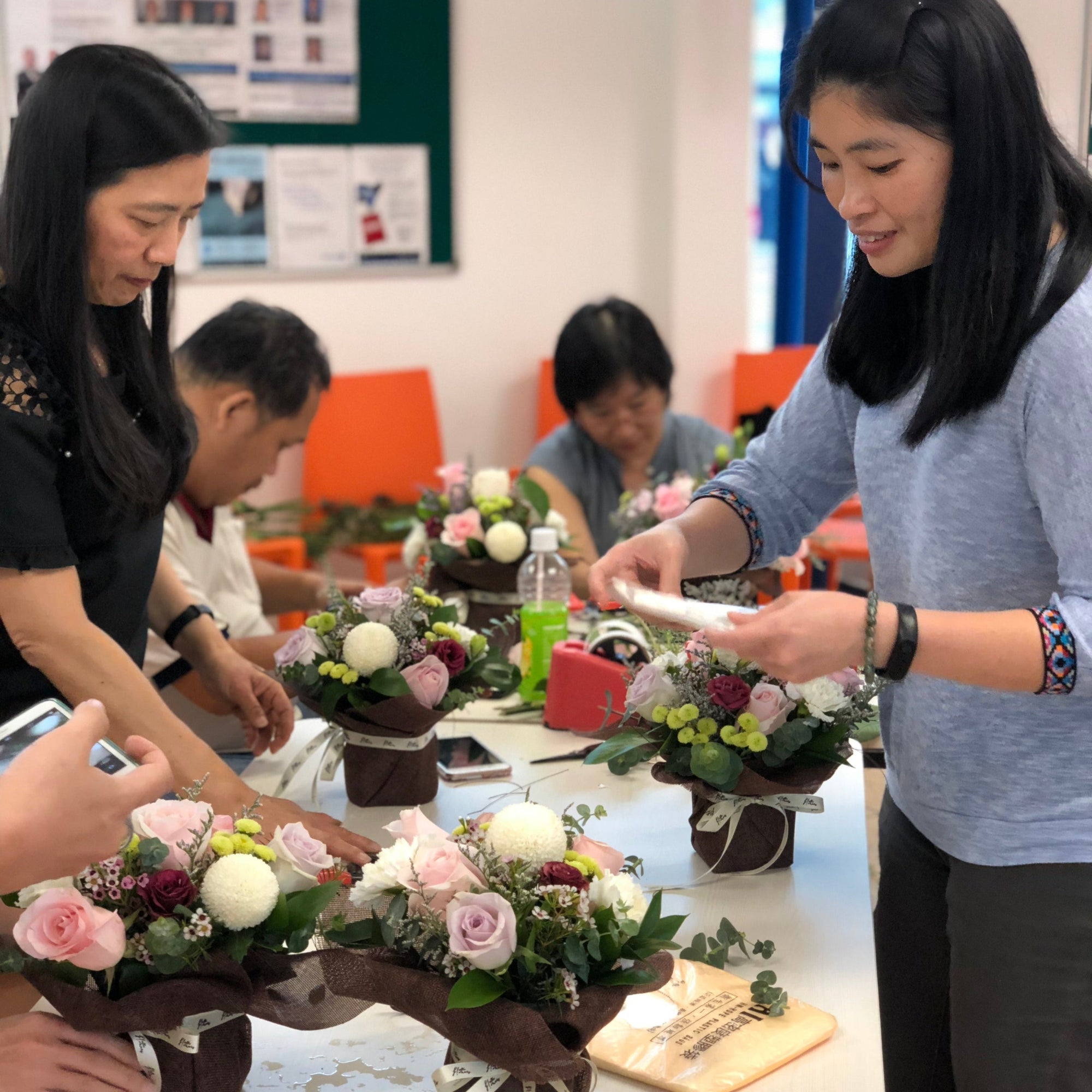 women joining therapeutic flower arrangement workshop