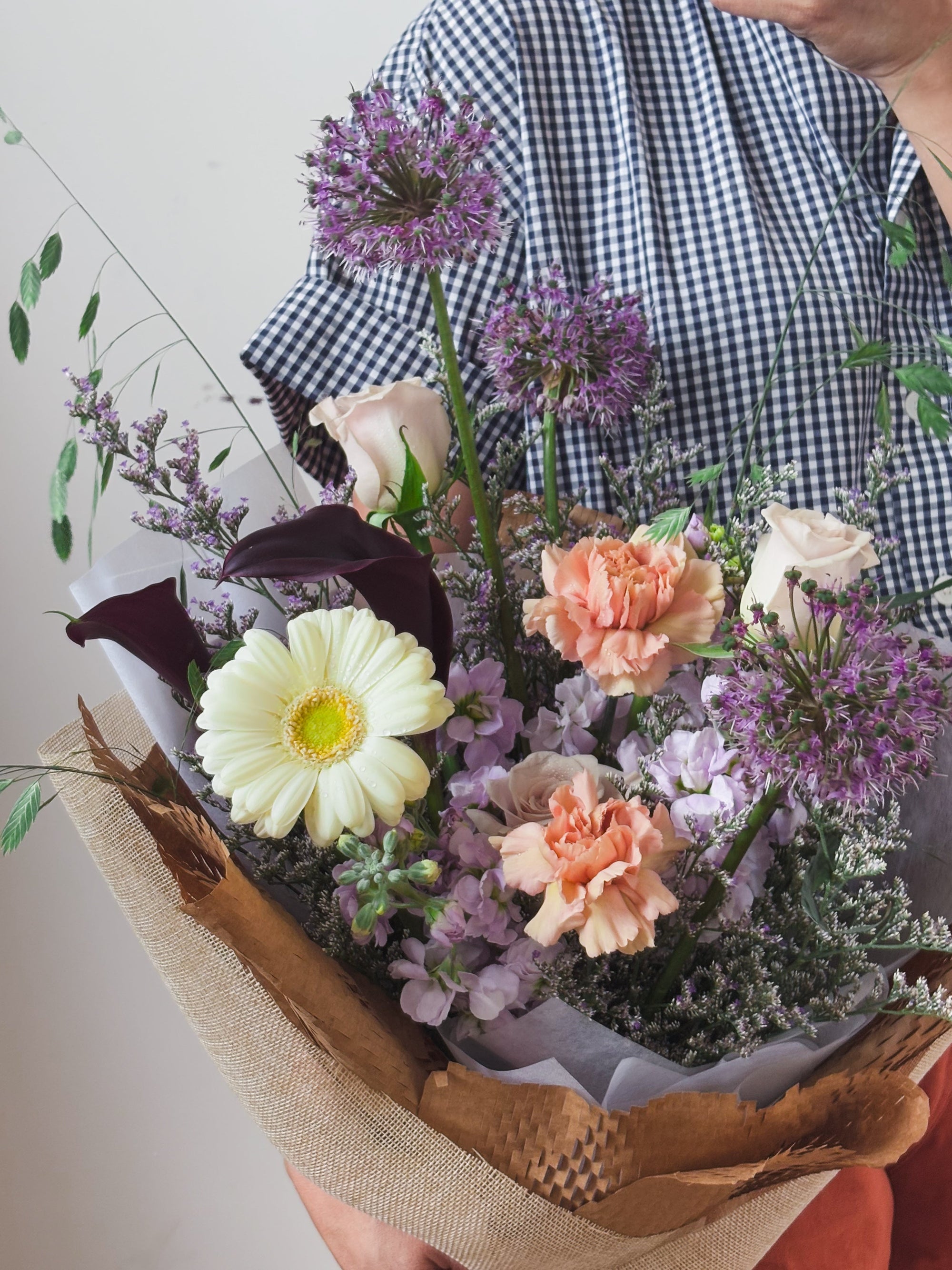 A Person holding a bouquet of fresh flowers