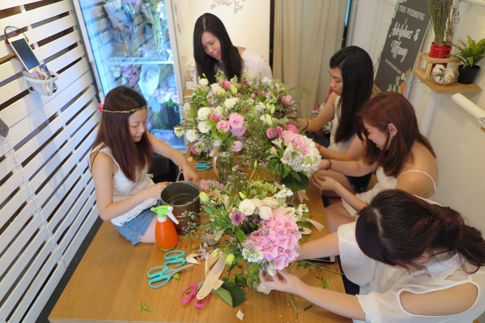 group of women arranging flowers on the table