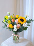 Sunshine in a Vase arrangement with bright yellow, orange and white blooms