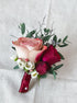 Fresh flower boutonnière in soft tones for a wedding ceremony