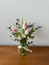 Thea tulip and tanacetum daisy arrangement in a jar with mixed pastel blooms