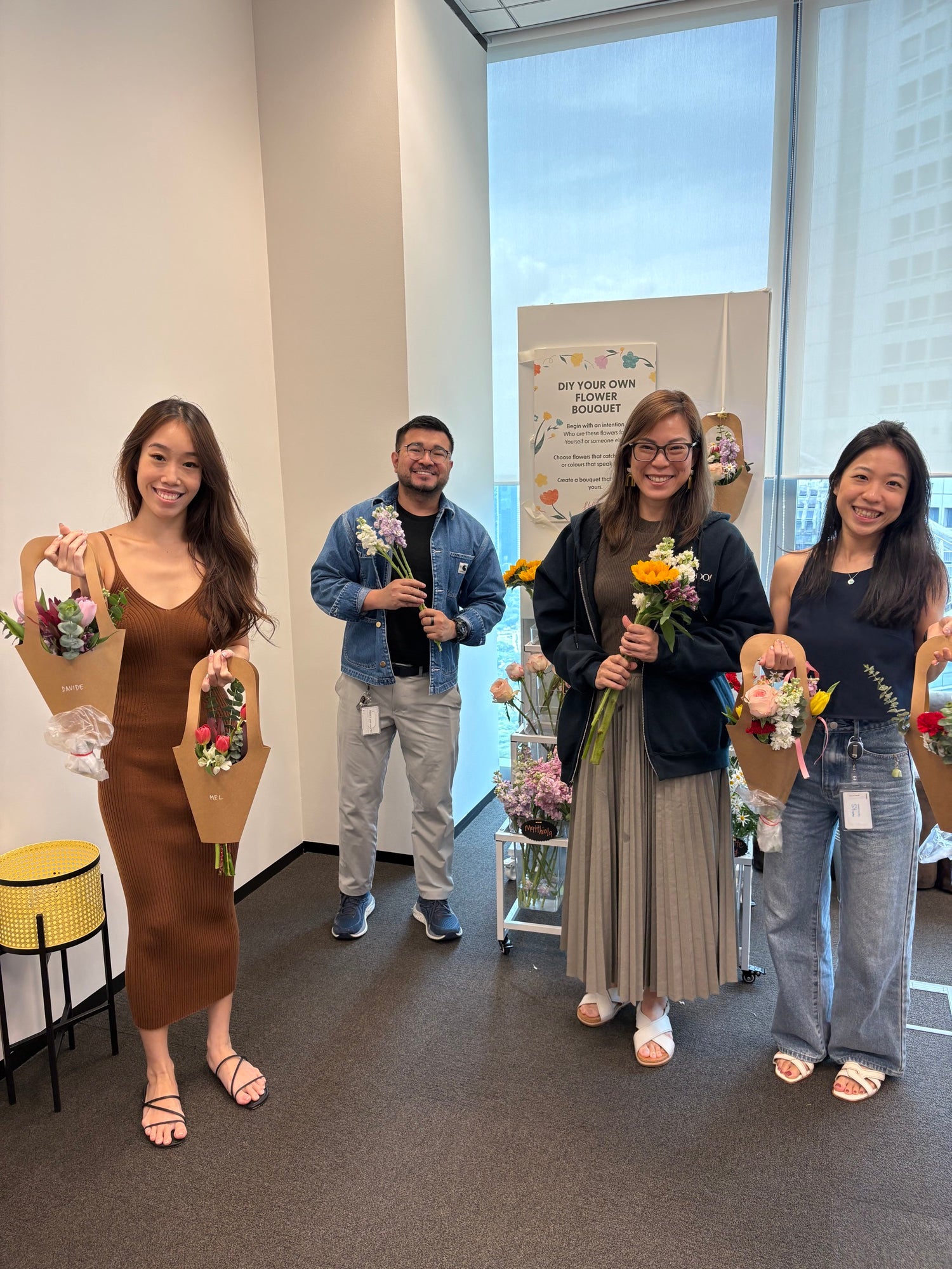 Guests with their hand-built mini bouquets at a Hello Flowers DIY fresh flower bar